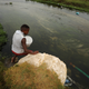 A man fills up a containers with water from a polluted river near Cape Town as the city’s water crisis mounts on Feb. 2, 2018.